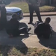 Virginia University of Lynchburg students shown handcuffed as police officers stand over them.